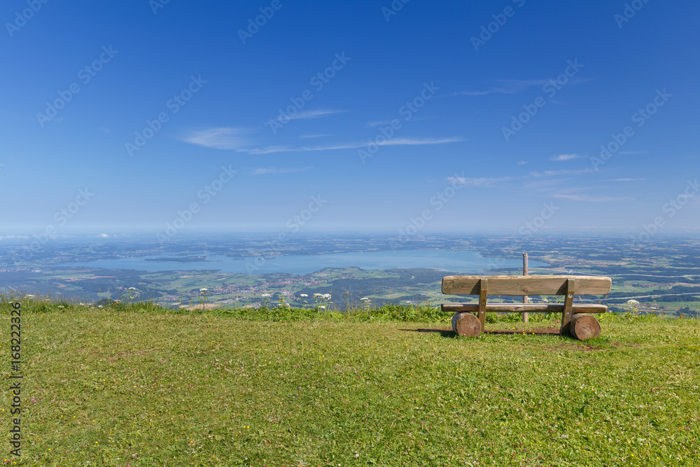 Bench at lookout on Summit of Mount Hochfelln overlook at Lake Chiemsee on a sunny summer day at early Morning Bench at lookout on Summit of Mount Hochfelln overlook at Lake Chiemsee on a sunny summer day at early Morning