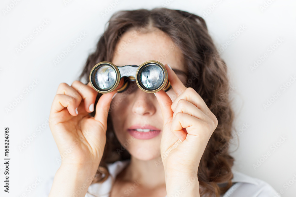 young woman looking through binoculars young woman looking through binoculars