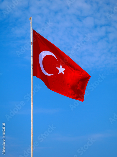 turkish flag against blue sky in background