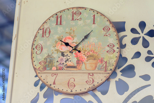 Vintage watch on a wooden background. Old wooden clock hanging on the old wooden wall