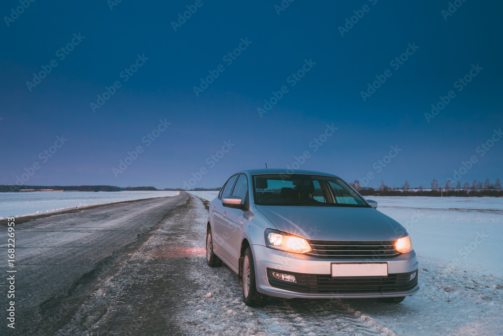 Car Sedan In Country Road At Winter Evening