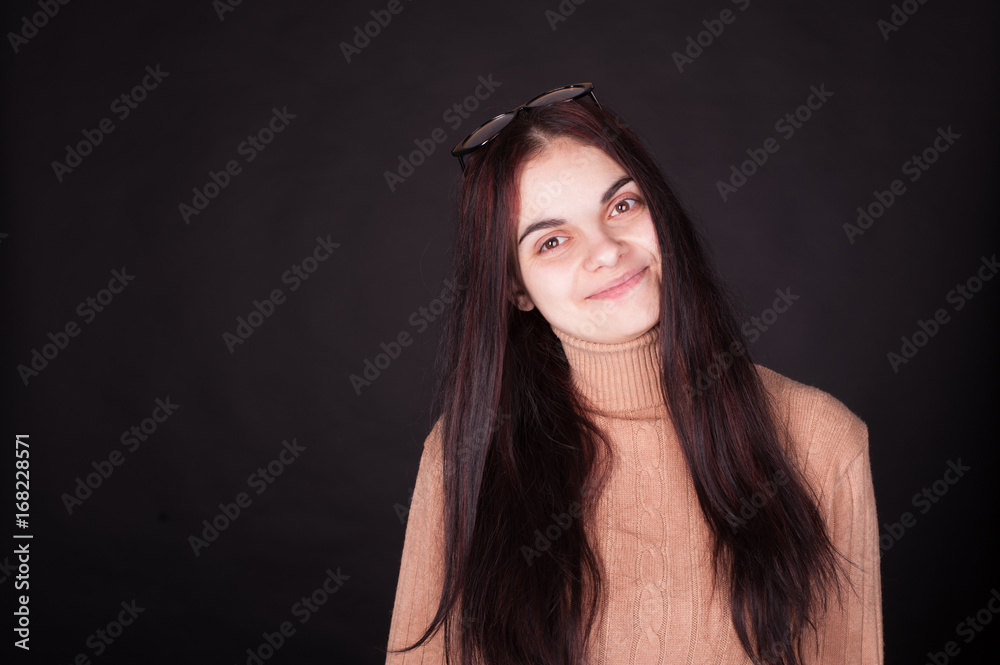 Studio portrait of young brunette woman in cozy winter sweater - natural pure skin, no make up Studio portrait of young brunette woman in cozy winter sweater - natural pure skin, no make up