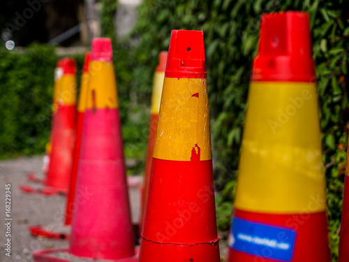 Traffic cones by a leaf covered stone wall