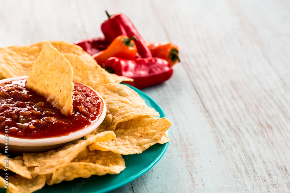 Tortilla Chips With Salsa and Sweet Peppers in Background