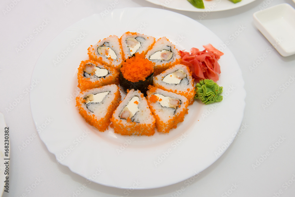 Sushi Set sashimi and sushi rolls served on stone slate. Sushi