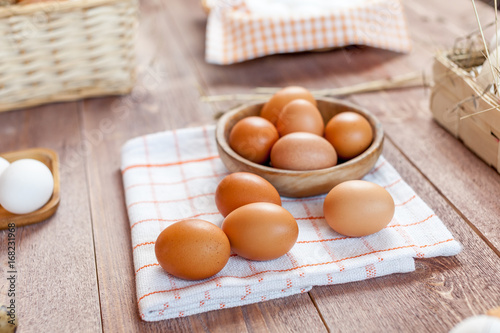 Close-up view of raw chicken eggs on wooden background