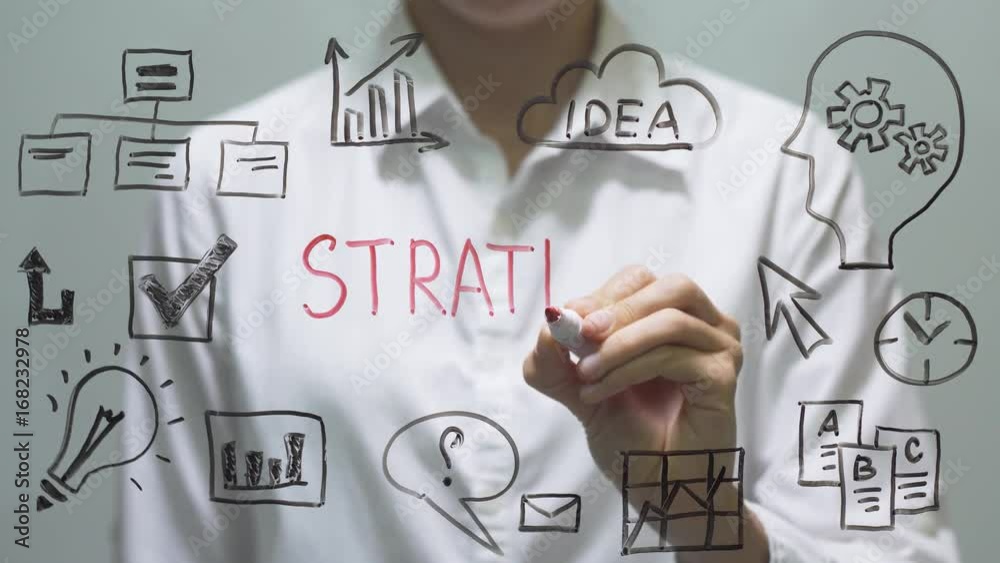 Woman writing STRATEGY on transparent screen. Businesswoman write on board.