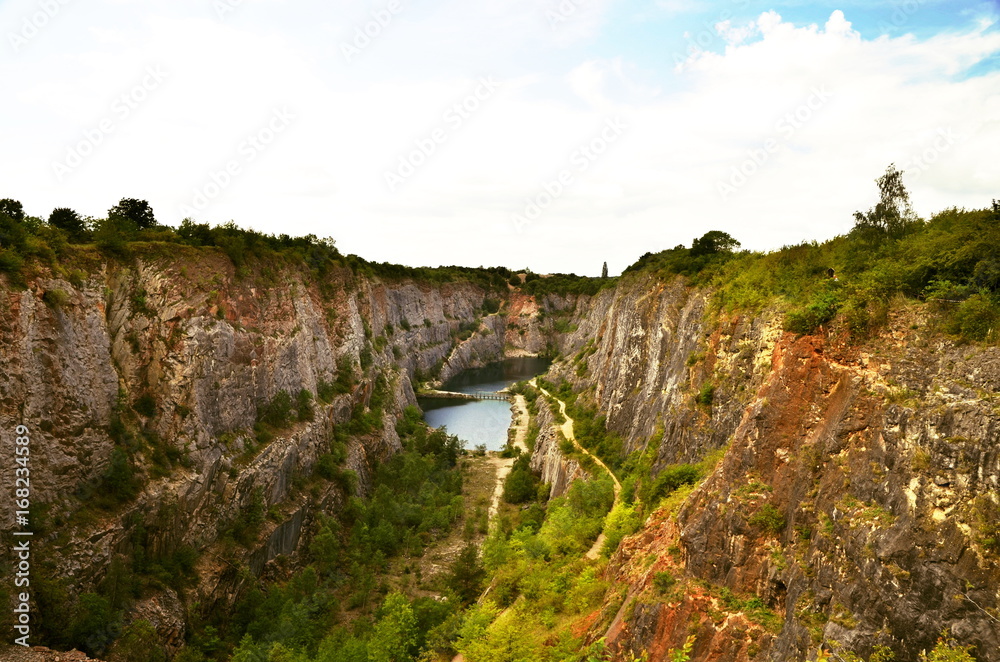 A view of a flooded quarry during a sunny day