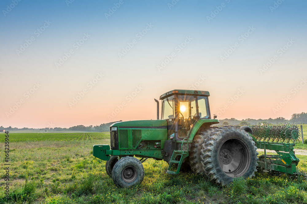 Tractor in a field on a Maryland Farm near sunset Tractor in a field on a Maryland Farm near sunset
