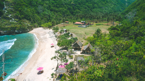 Wallpaper Mural Lila Sunbed on beautiful idyllic white sand Atuh beach. Clear blue ocean waves rolling to the beach. Nusa Penida, Bali, Indonesia Torontodigital.ca