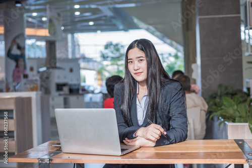 Asian young business freelance woman happiness working online business with laptop and cell phone in cafe shop. Working concept. Free Download Asian young business freelance woman happiness working online business with laptop and cell phone in cafe shop. Working concept. - GFXLoad