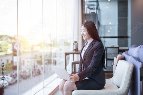 Asian young business freelance woman happiness working online business with laptop and cell phone in cafe shop. Working concept.