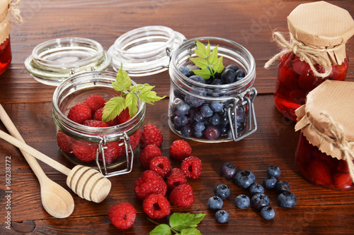 blueberries and raspberries in jars for the winter tea