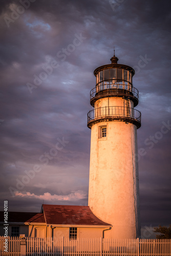 New England Lighthouse at dusk with dramatic sky