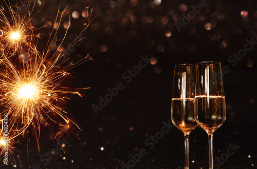 Background with sparkling miracle candle and champagne