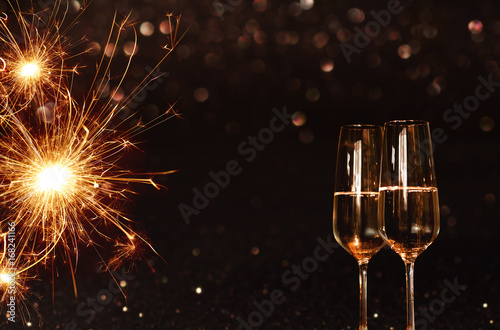 Background with sparkling miracle candle and champagne photo