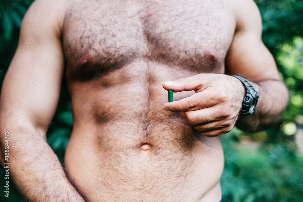 Naklejka premium man showing holding pack of pills