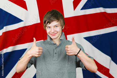 Thumbs up Brit boy in front of Union Jack flag