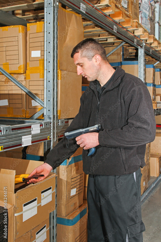 Worker with barcode scanner in warehouse Worker with barcode scanner in warehouse