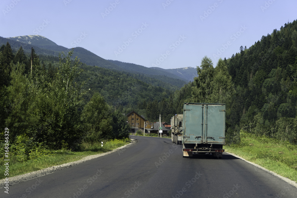Truck traveling on the highway in the mountains Truck traveling on the highway in the mountains