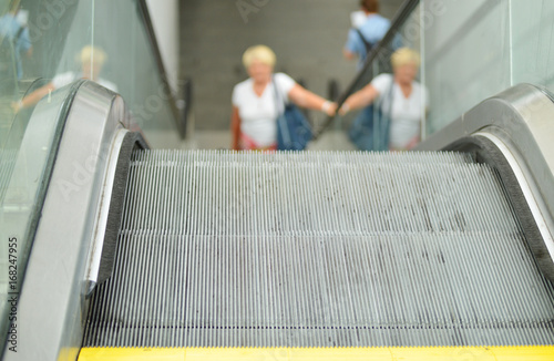 escalator and woman going up, blurred