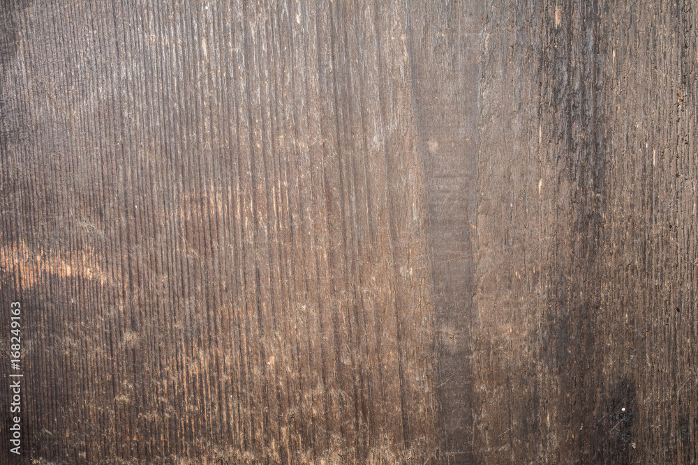Dark texture of old natural wood with cracks from exposure to sun and wind Dark texture of old natural wood with cracks from exposure to sun and wind