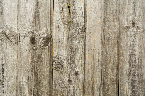 Dark texture of old natural wood with cracks from exposure to sun and wind
