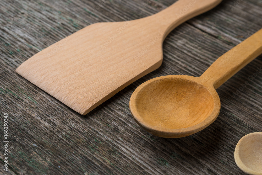 Handmade wooden spoons on a wooden board, kitchen tools Handmade wooden spoons on a wooden board, kitchen tools