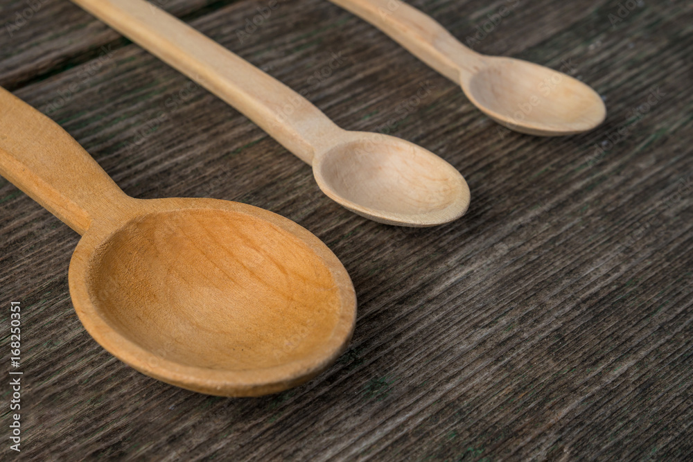 Handmade wooden spoons on a wooden board, kitchen tools Handmade wooden spoons on a wooden board, kitchen tools