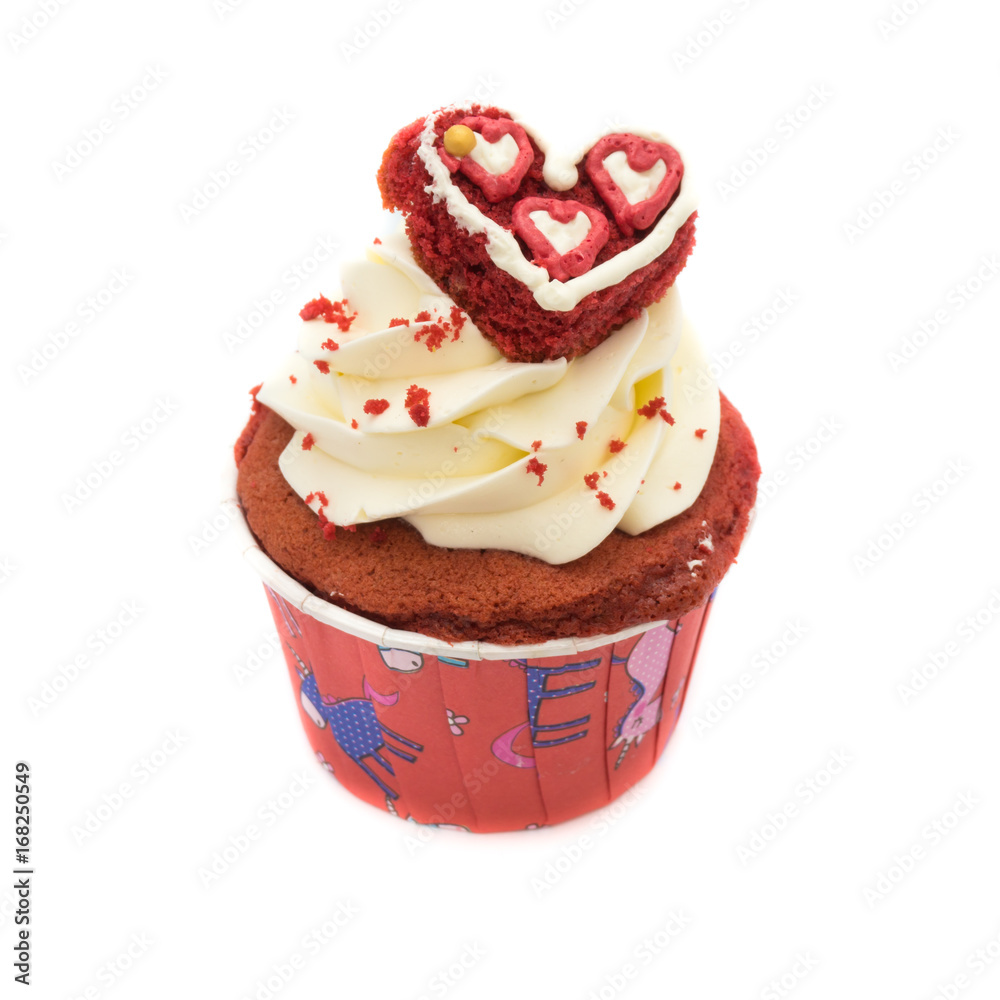Chocolate cupcake decorated with red heart icing and sprinkles isolated on white