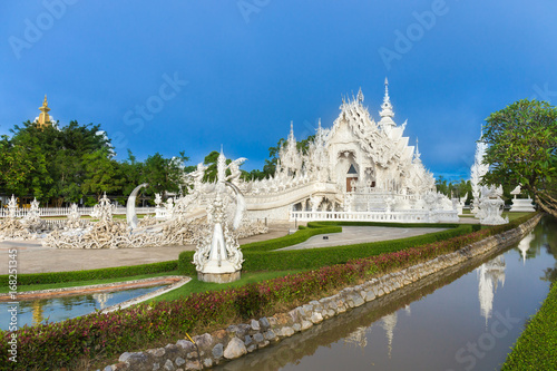 Wat Rong Khun The White Abstract Temple and pond with fish  in Chiang Rai  Thailand. Popular and famous in vacation for tourist.