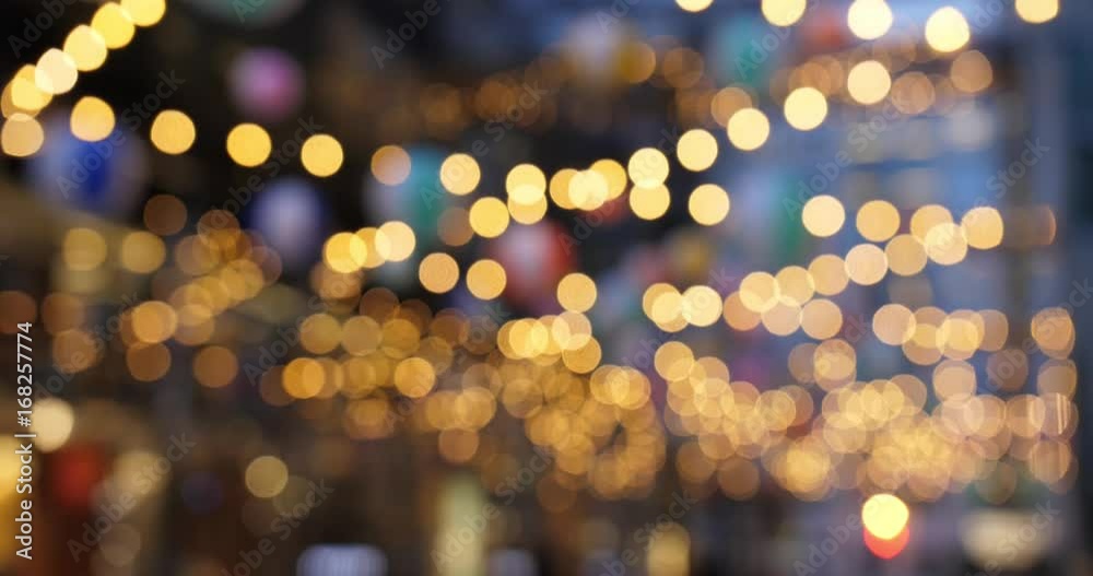 Abstract blurred bokeh hanging lights in a large city.  	