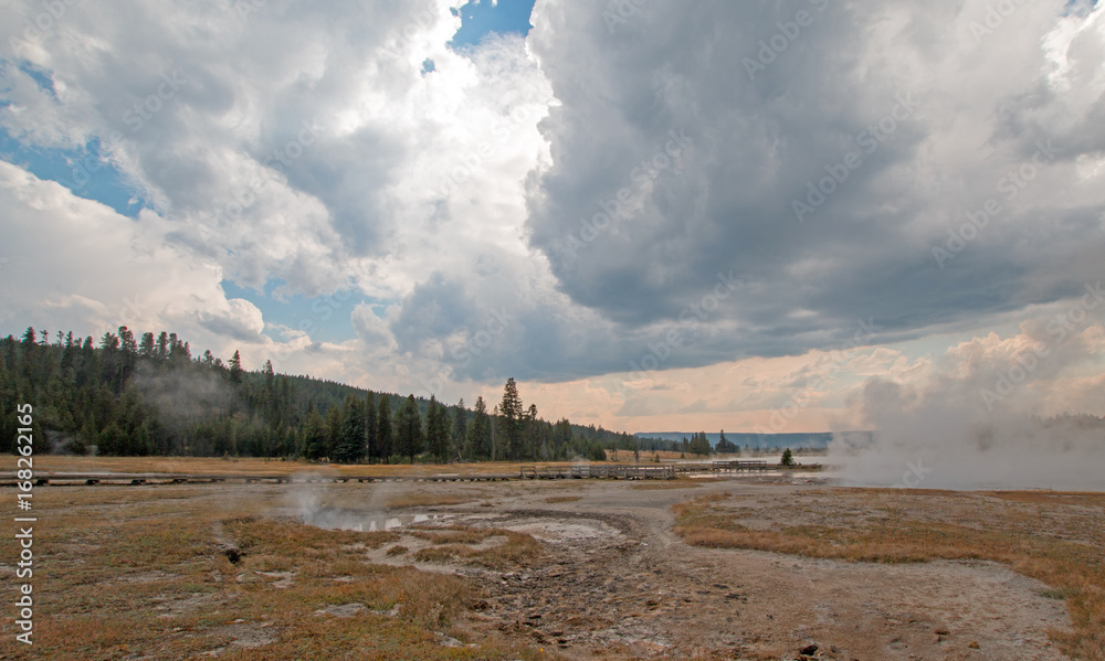 Steam rising off Black Warrior hot springs geyser and Hot Lake in Yellowstone National Parks Lower Geyser Basin in Wyoming United States
