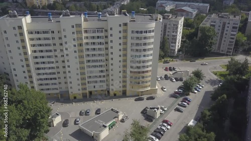 Aerial view on sleeping neighborhood in district with new houses. Business and culture concept - panoramic modern district skyline bird eye aerial view under dramatic sun and morning blue cloudy sky photo