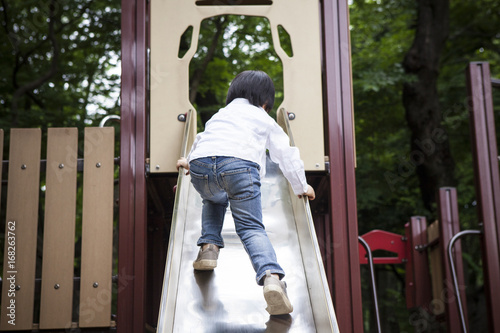 The boy climbing the slide
