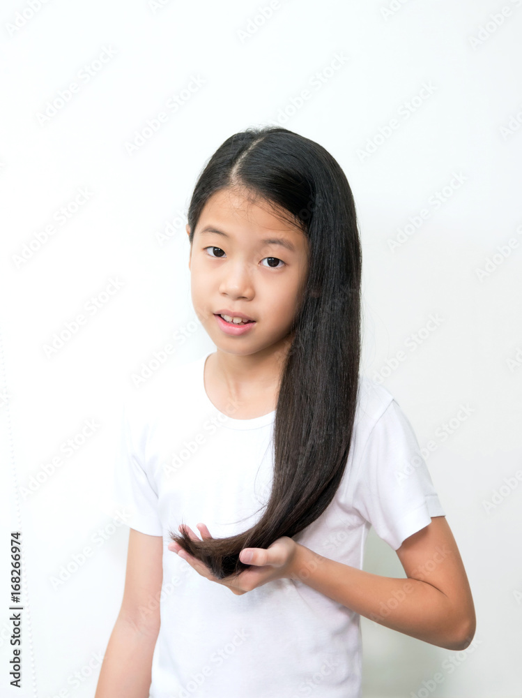 Portrait of beautiful young Asian teenage girl with long wavy black hair on  white background. Pre