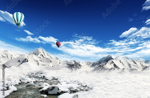 Hot air balloons flying over the mountains
