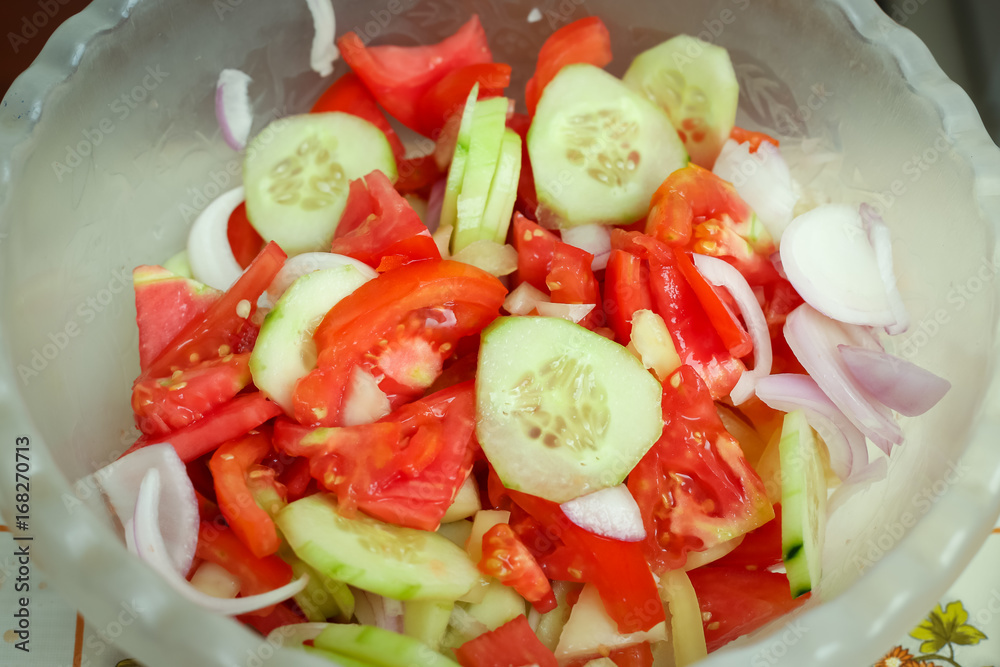 Detail of preparing mixed vegetable salad in kitchen. Detail of preparing mixed vegetable salad in kitchen.