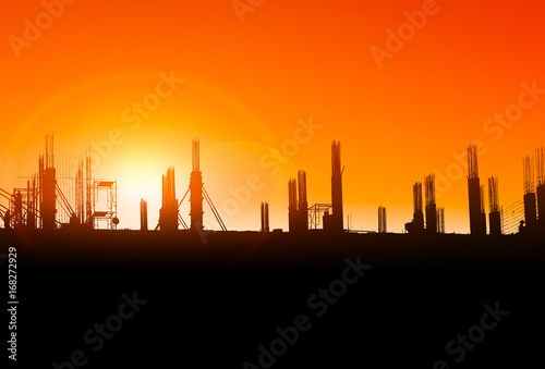silhouette of construction on industry site at concept sunrise time with sun light effect background with copy space add text