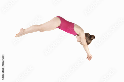 Little caucasian female 6 years old athlete in diver pose photo