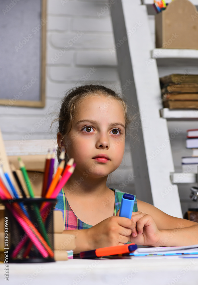 Kid and school supplies on classroom background Kid and school supplies on classroom background