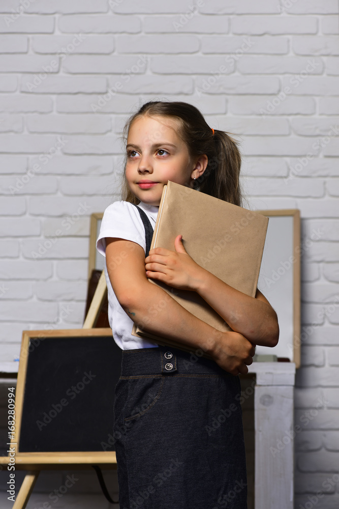 Back to school and childhood concept. Girl with textbook Back to school and childhood concept. Girl with textbook