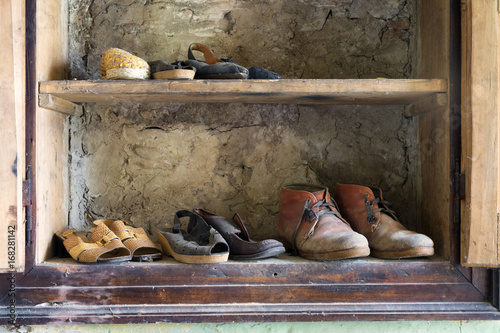 Wardrobe full of old shoes.