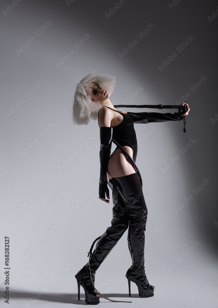 Young beautiful dancer is posing in studio