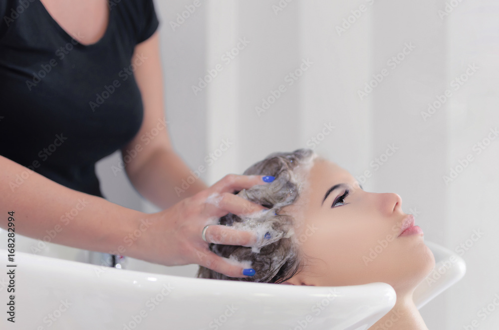 Girl washing hair in salon Girl washing hair in salon