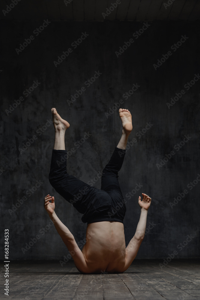 Young beautiful dancer is posing in studio