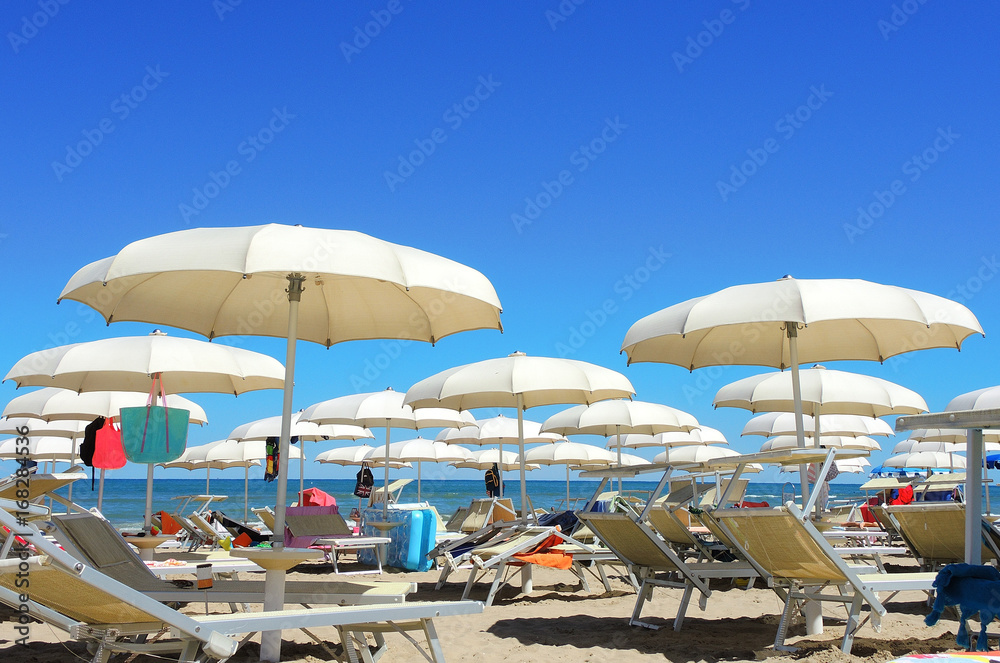 Umbrellas and gazebos on Italian sandy beaches. Adriatic coast. Emilia Romagna region