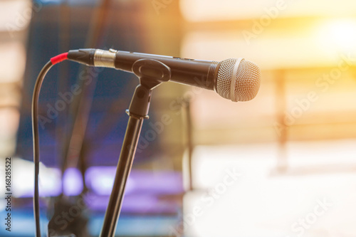 Microphone on abstract blurred indoor background with sunlight of sunset