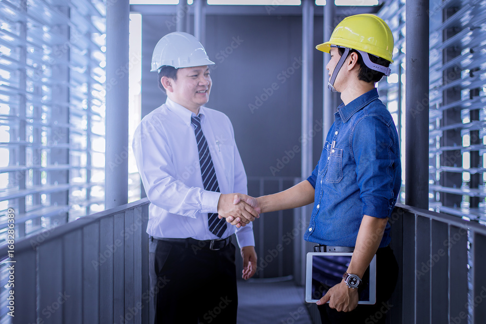 contractor and engineer hand shake while business meeting contractor and engineer hand shake while business meeting