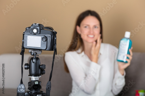 Female Blogger Holding Product Recording Video With Camera